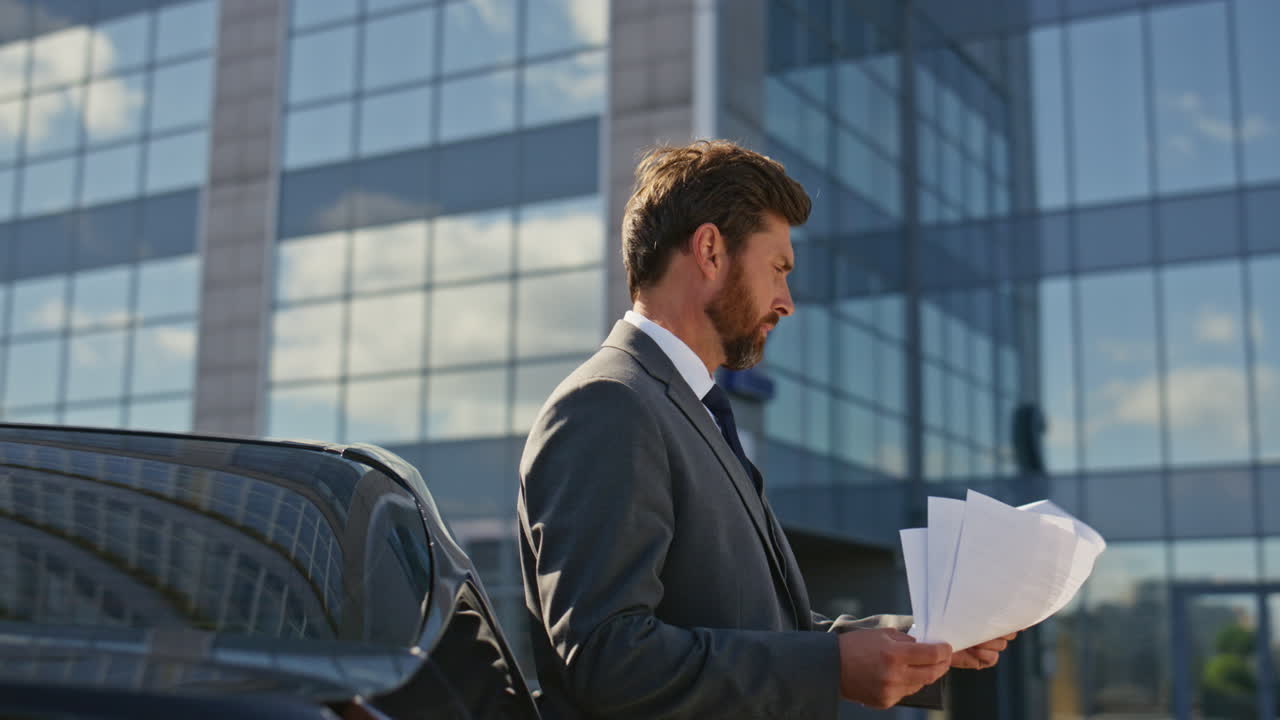 Smart lawyer analyzing documents on sunny street close up. Businessman reading