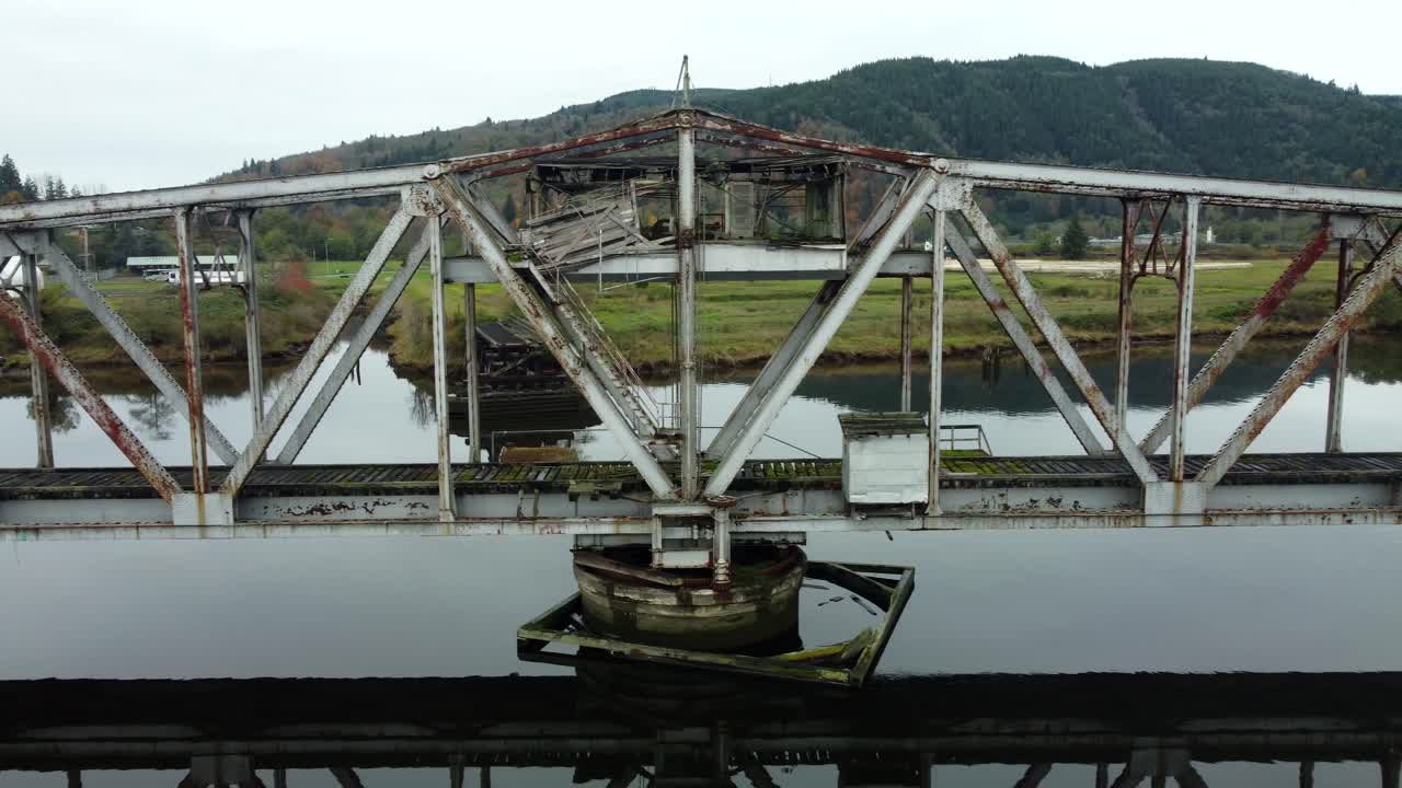 US, WA, Raymond, 2025-10-28 - Drone view of the abandoned train trestle rotating bridge on the Willapa River