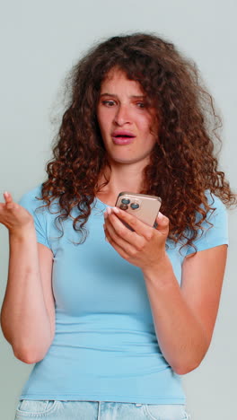 woman surprised scrolling news on smartphone raising eyebrows amazed expression unexpected shock