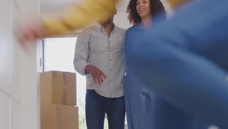 excited children with parents exploring new home on moving in day