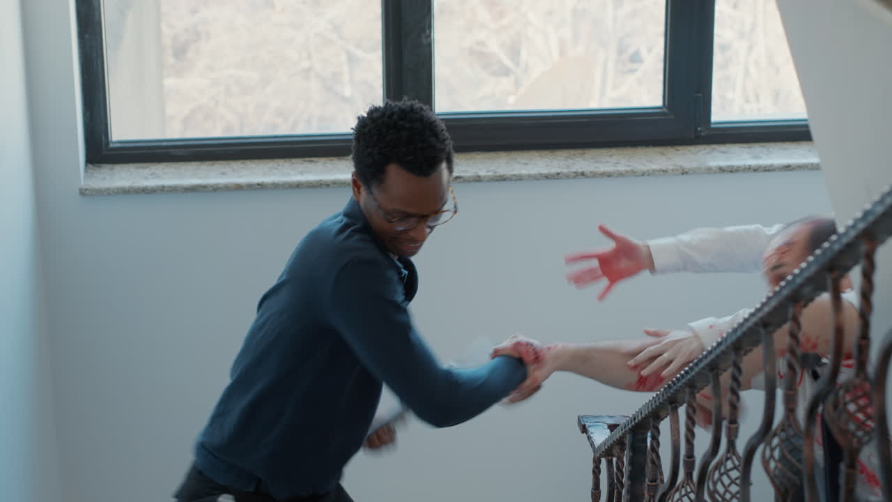 Terrified man on emergency stairway running away from spooky looking apocalypse zombies