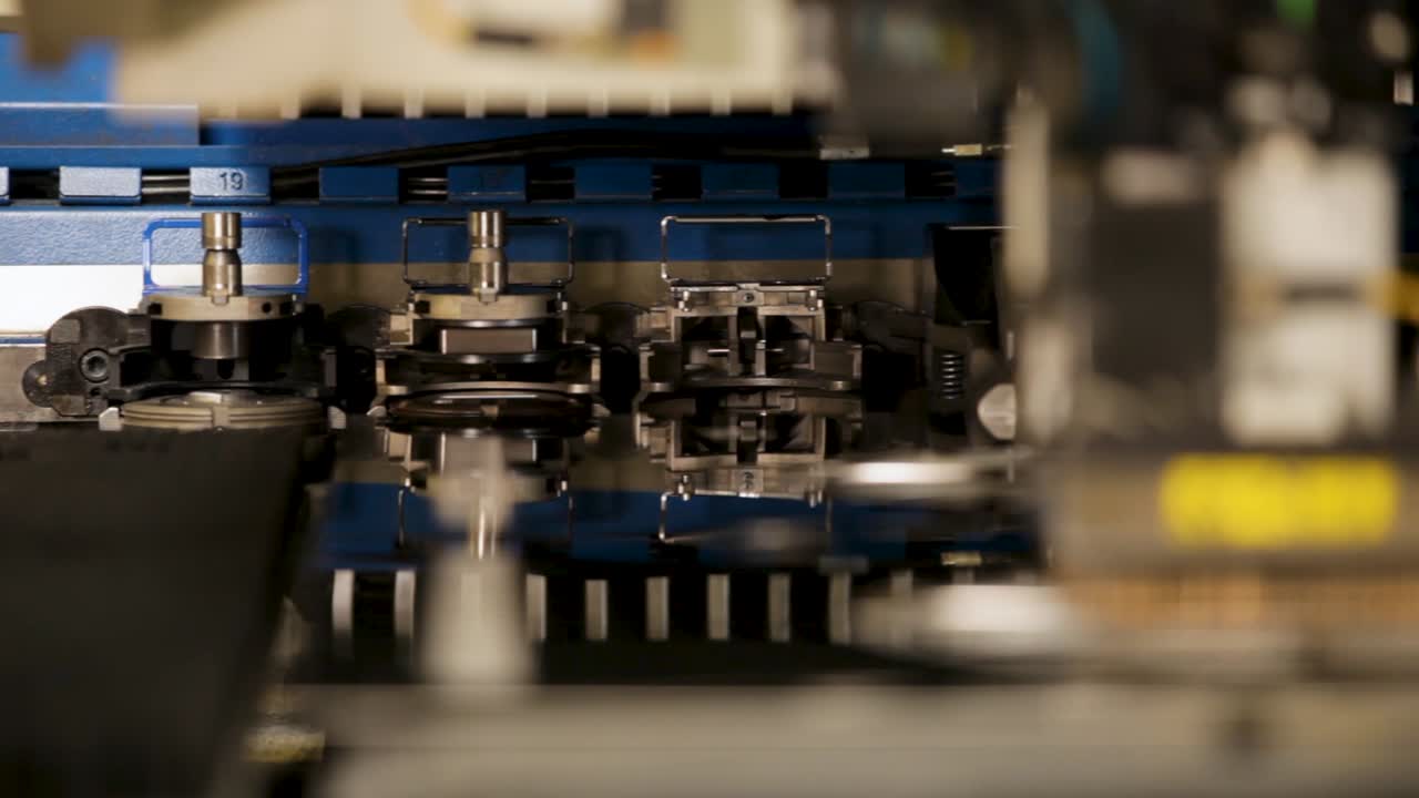 Industrial robotic handling metal sheets in factory, shallow focus