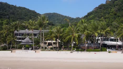 aerial view along white sand beach at koh chang with palm trees and beach front hotels