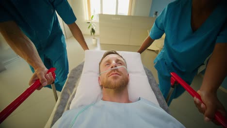 hospital staff moving a patient on a stretcher