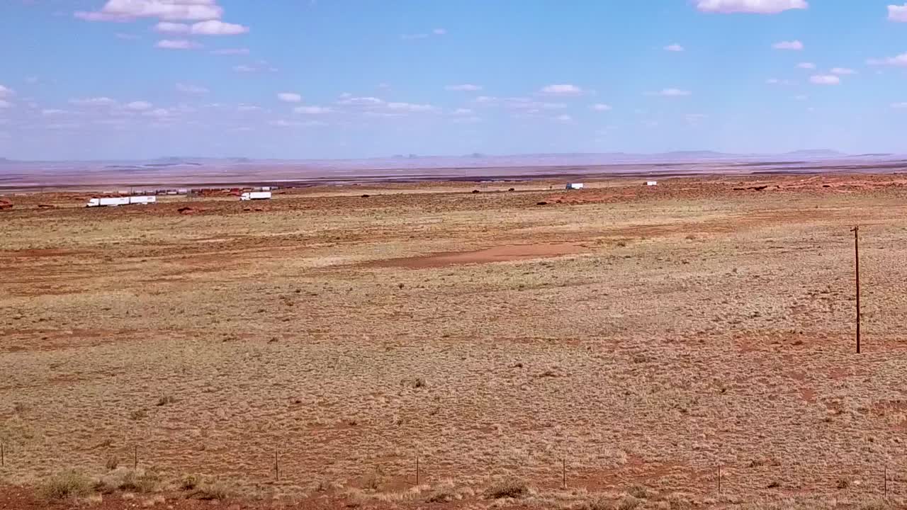 Drone over the Arizona desert near Winslow with the i40 in the background.