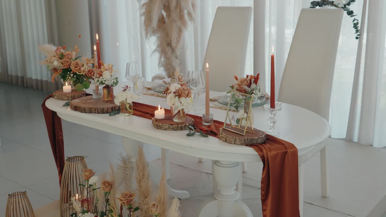 elegantly decorated wedding table with flowers candles and wood accents under soft daylight