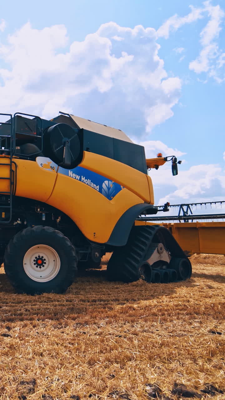 Harvesting machine working in field. Combine harvester working on the large wheat field