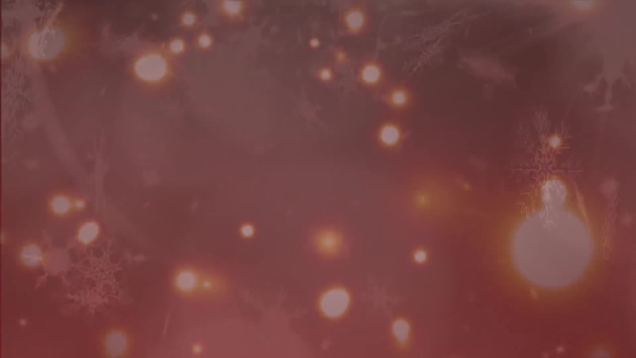 copos de nieve y manchas de luz que se mueven contra un fondo rojo