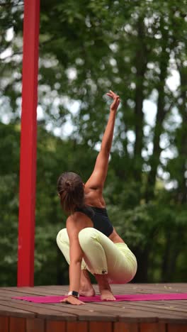 woman practicing yoga outdoors