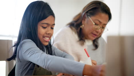 Home,-grandmother-and-learning-child-with-paper