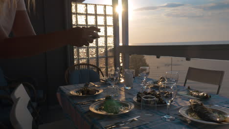 Girl-making-photo-of-served-dinner-with-cellphone