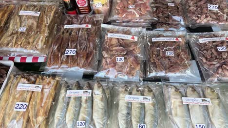 assorted dry seafood packets on market stall.