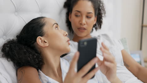 Phone,-relax-and-lgbt-couple-in-bed-watching-video