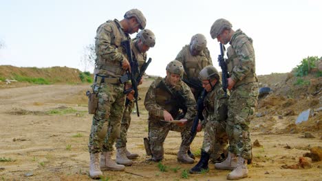 Vorderansicht-Von-Gemischtrassigen-Militärsoldaten,-Die-Während-Der-Militärischen-Ausbildung-Auf-Dem-Feld-Planen,-4k