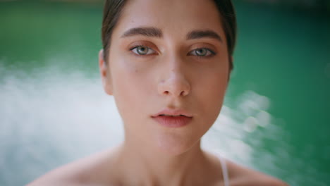 Portrait woman looking camera blue lagoon. Girl face posing nature seductively