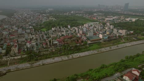 aerial pan shot of hanoi cityscape situated beside a lake in vietnam
