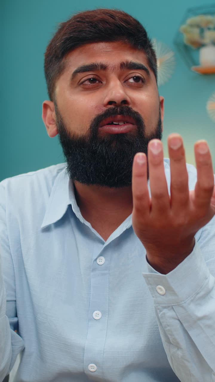 Indian man hides face in hands devastated by loss breakup bankruptcy deep despair sorrow alone room