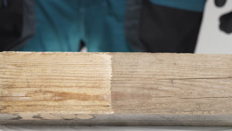 inspecting wood plank with different treatment