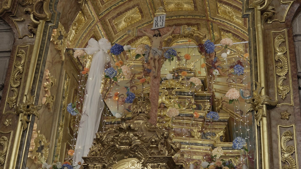 Close up view of Ornate Altar Crucifix with Gold Leaf and Flowers