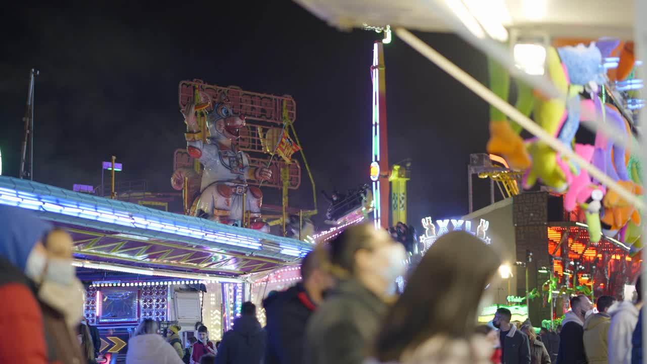 Night Funfair with People Wearing Masks