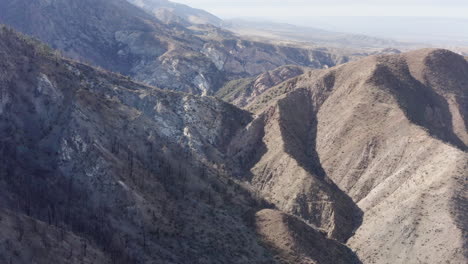 rugged mountain landscape with canyons and arid terrain