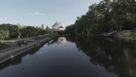 city park by the river with modern architecture