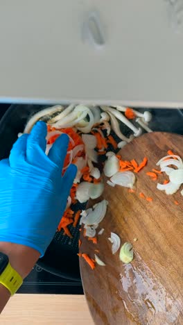 cooking mushrooms and carrots in a pan