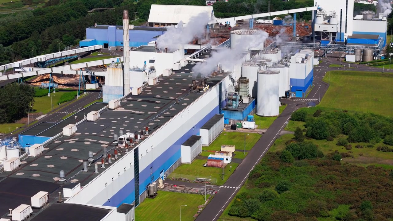 Aerial View, Paper manufacturing site with steam rising from processing buildings at Shewalton, North Ayrshire, Scotland