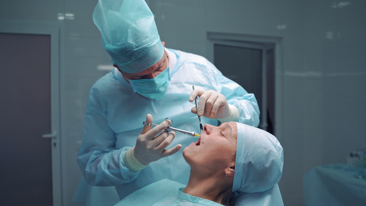 the dentist is making anesthesia to the patient