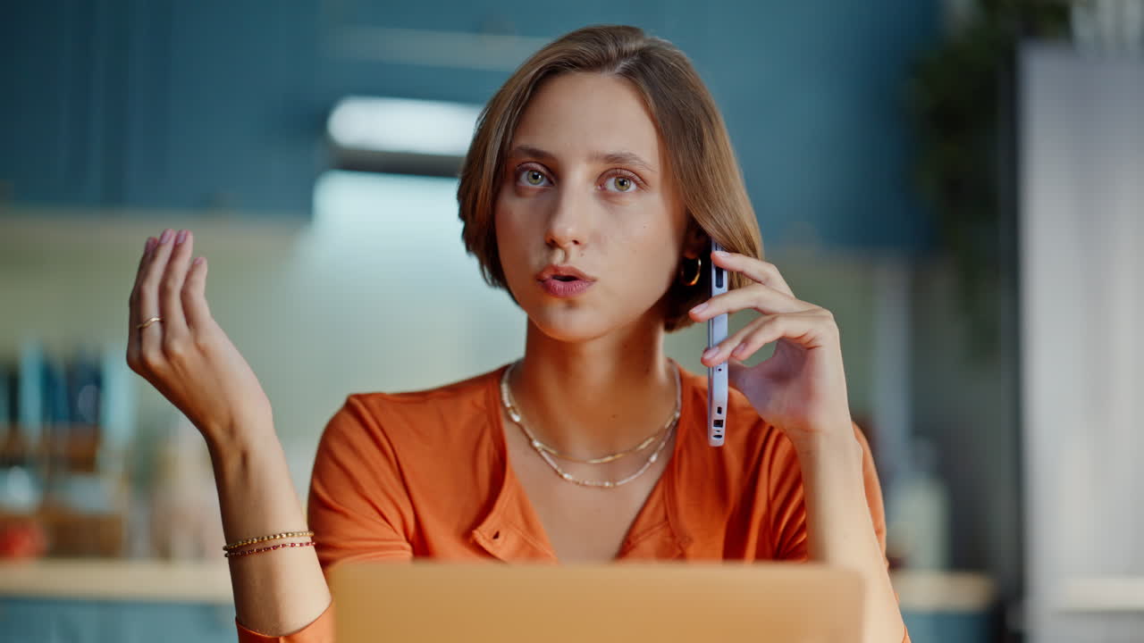 Woman making order phone looking laptop at home closeup. Freelancer discussing