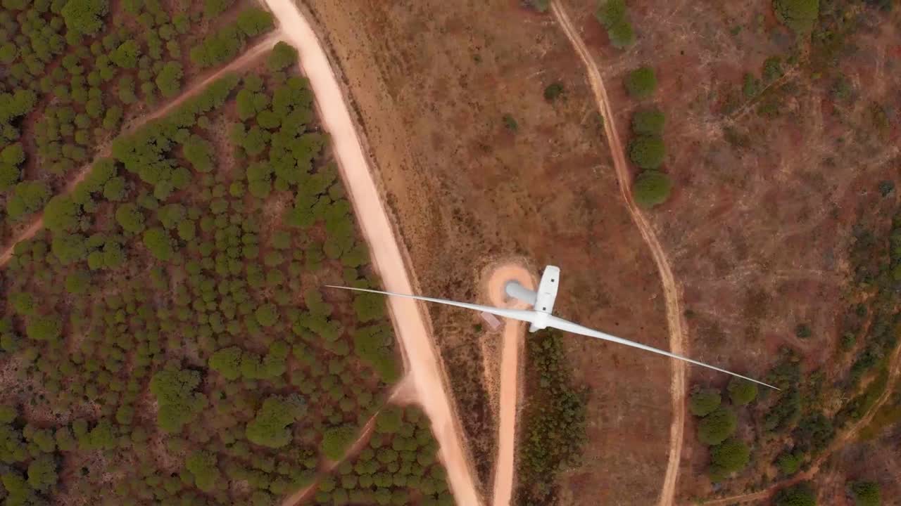 Aerial shot flying over a wind turbine in Barao de Sao Joao, Portugal.