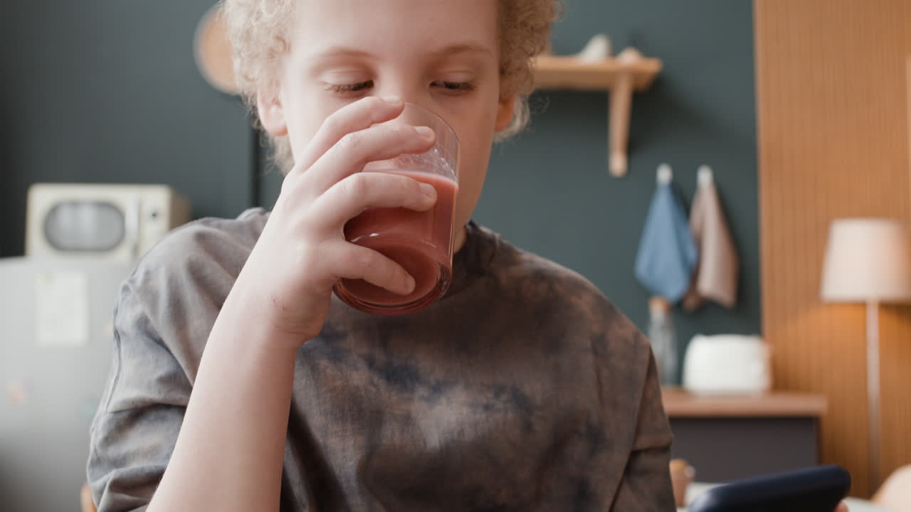 Young person drinking beverage at home