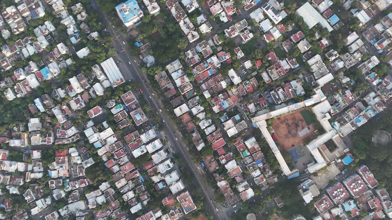 Sweeping drone shot over suburban area with mix of villas and apartments