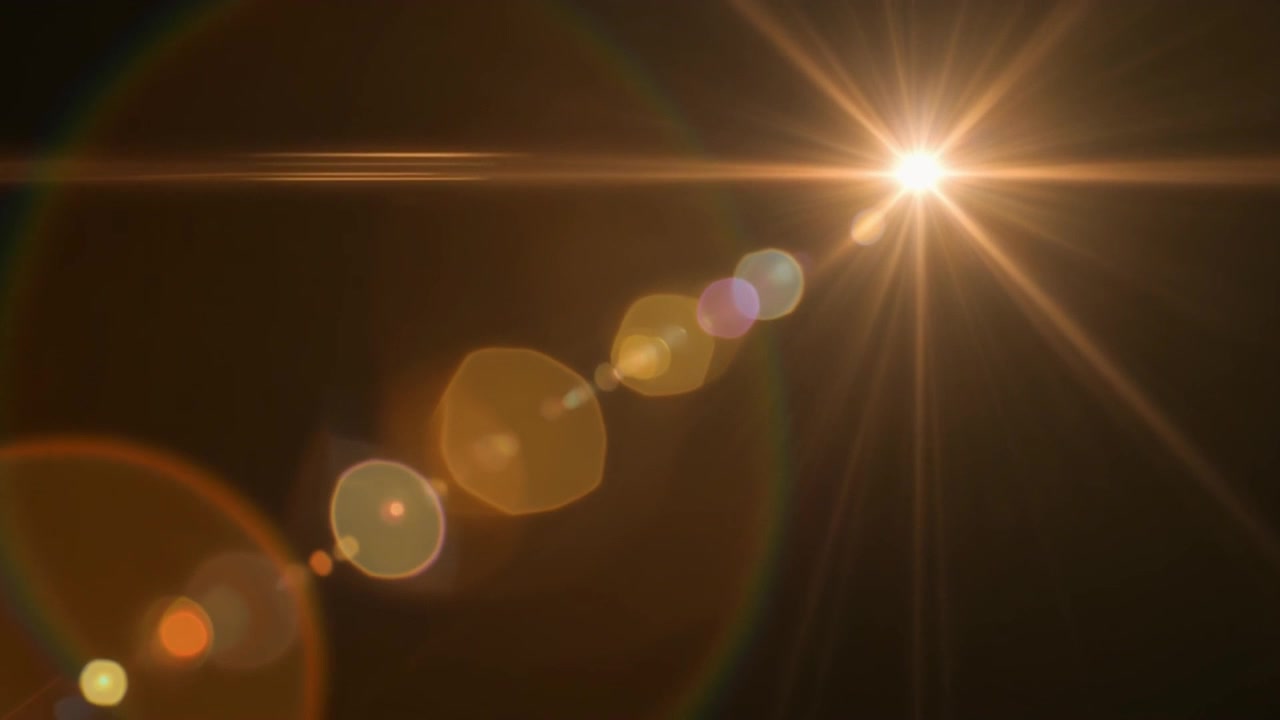 Luminoso effetto flare dorato su sfondo scuro