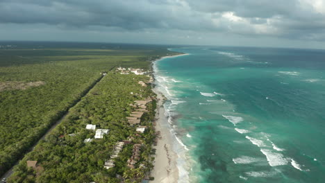 Flight-down-Tulum,-Beach-with-a-cloudy-sky