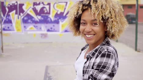 Trendy-young-woman-sitting-on-a-skateboard