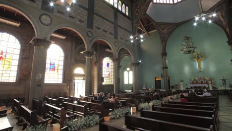 walking inside a catholic church with sunbeams through the windows