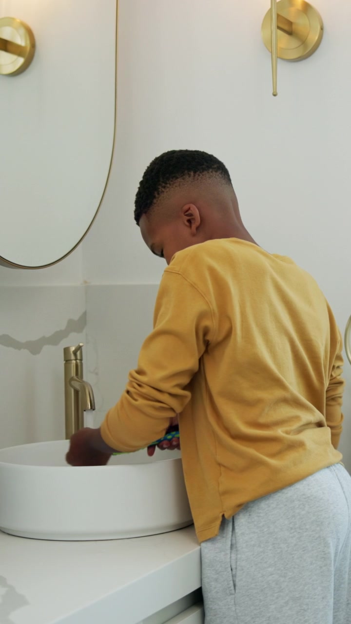 Young Boy Washing Face and Brushing Teeth in Modern Bathroom