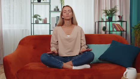 Woman-breathes-deeply-with-mudra-gesture,-eyes-closed-meditating-with-concentrated-thoughts-peaceful