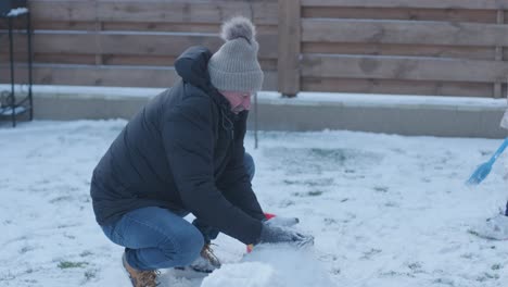 grandfather and granddaughter having fun in the snow