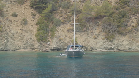 sailing boat on the mediterranean coast in a heavenly place with calm and crystalline sea