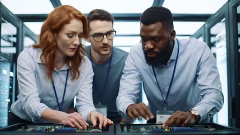 a collaborative team of technicians engaged in hardware installation and maintenance within a high-tech server room, demonstrating expertise in modern technology solutions