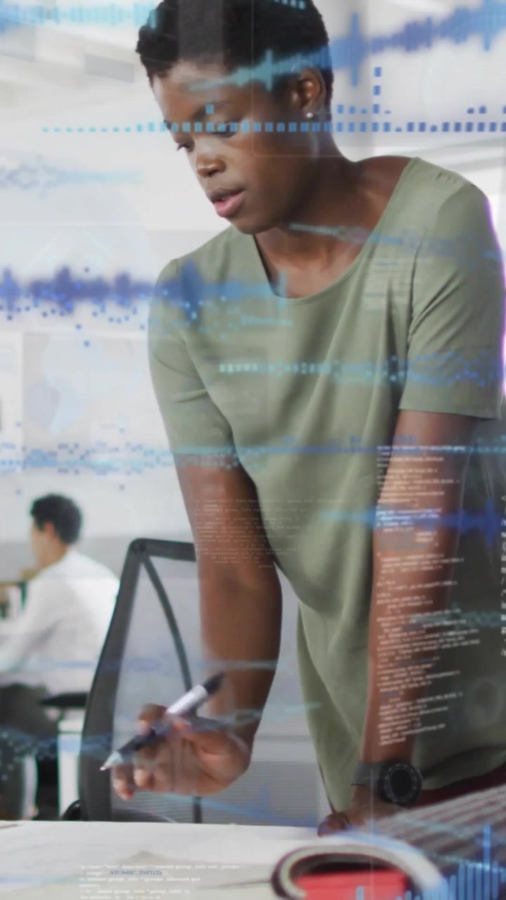 Vertical video: Woman bracing reading plans for design review data sweeping over plans pointing
