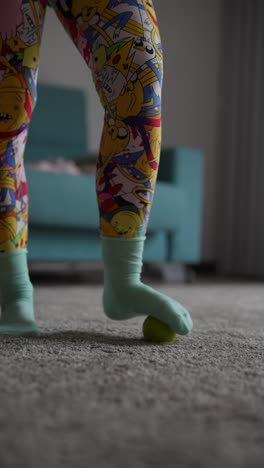 foot massage with a massage ball on a colorful leggings