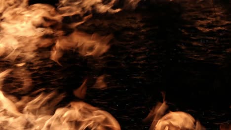 fire flames on black water nigh time