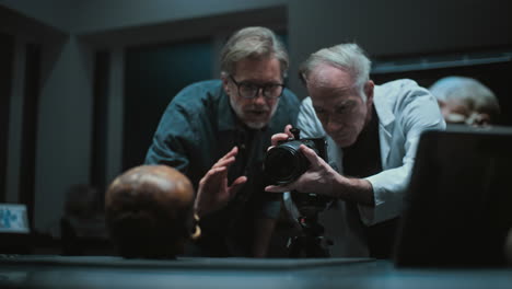 scientists documenting a human skull in a laboratory setting