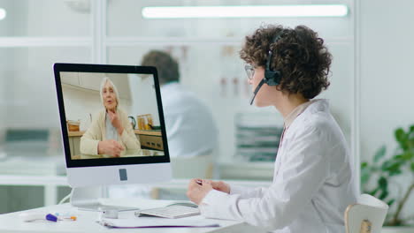Female Doctor Speaking with Senior Woman via Video Call