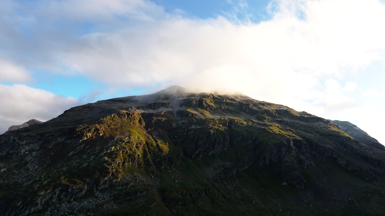 Majestic Swiss Alps mountain, clouds drift on serene sunny day