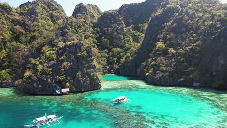 4k drone video flying back from a boat sailing around palawan in the philippines while on a boat tour from coron