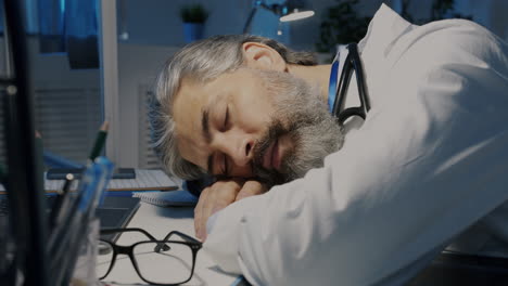 tired doctor sleeping at his desk